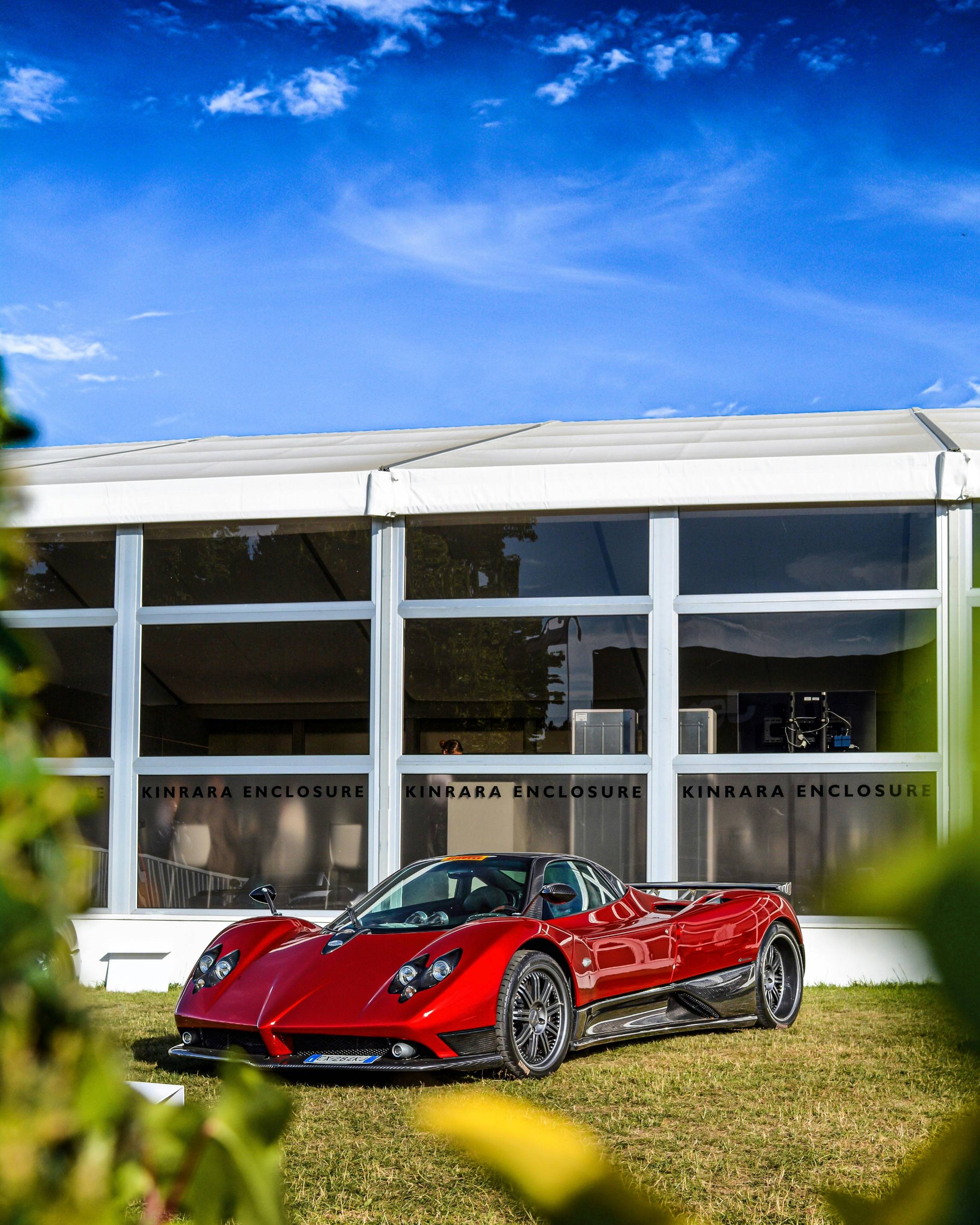 red sports coupe outside the building